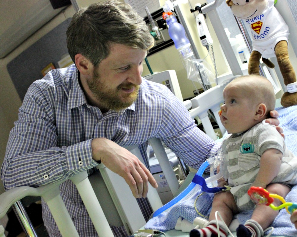 a father playing with his baby