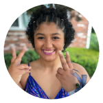 a teenage girl throwing up peace signs