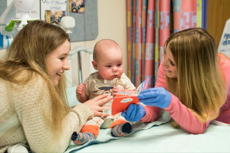 two women interacting with a baby