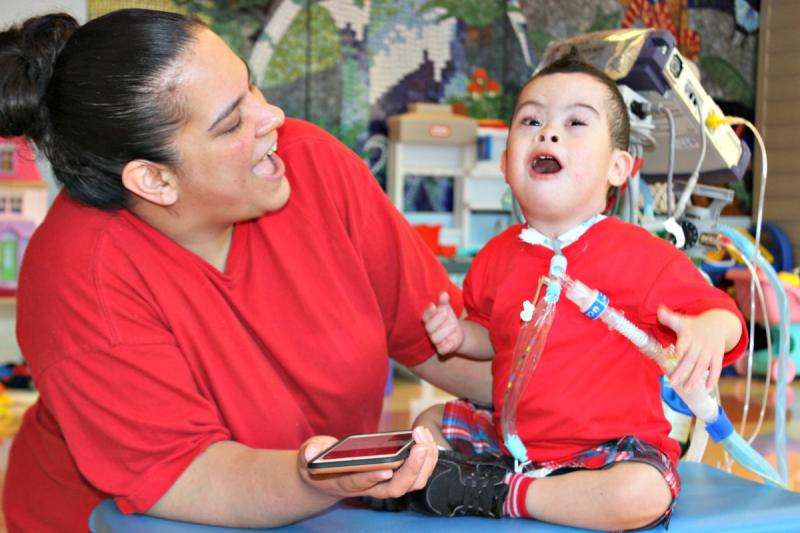 a happy boy with a medical provider helping him